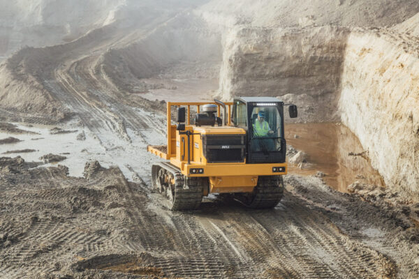 Bell Trucks America TC11A Tracked Carrier driving in a muddy quarry