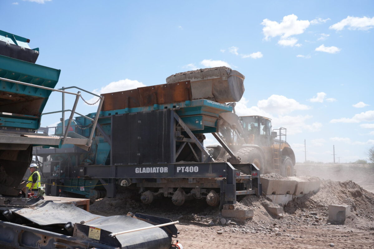 A wheel loader dumping material into a powerscreen gladiator PT400 jaw crusher