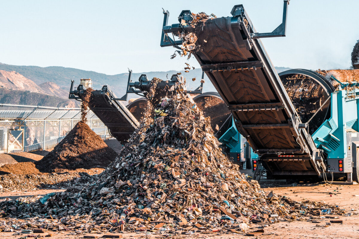 Terex Ecotec Phoenix 3300 Trommel Screener processing waste in a pile. 