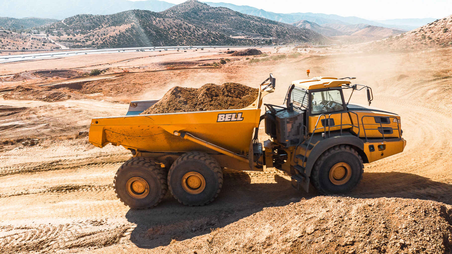 Bell B45E Articulated Dump Truck moving dirt uphill